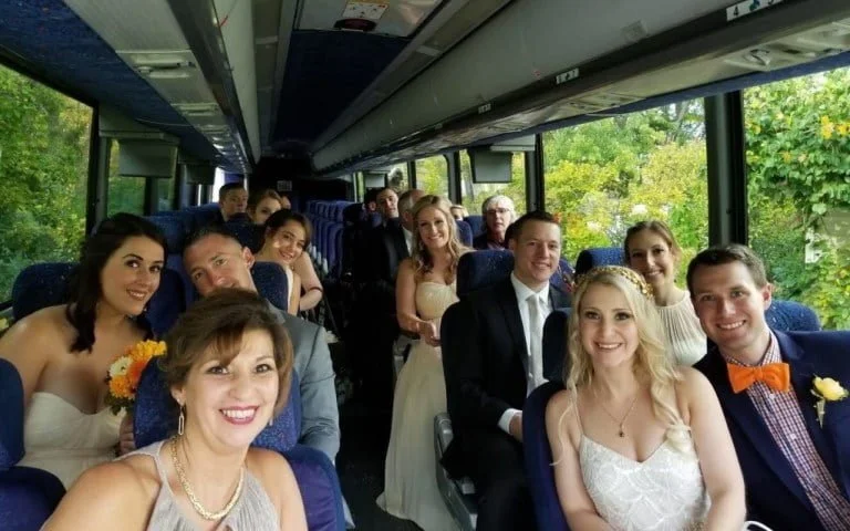Booking Wedding Transportation with Wade Tours- wedding party on a bus